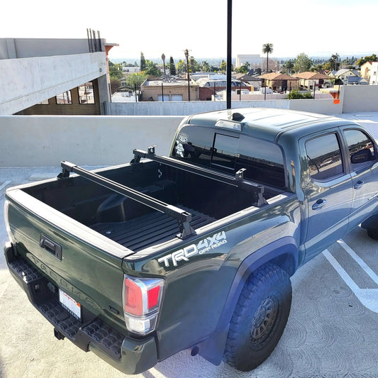 Rear side view of Toyota Tacoma cargo cross bars installed