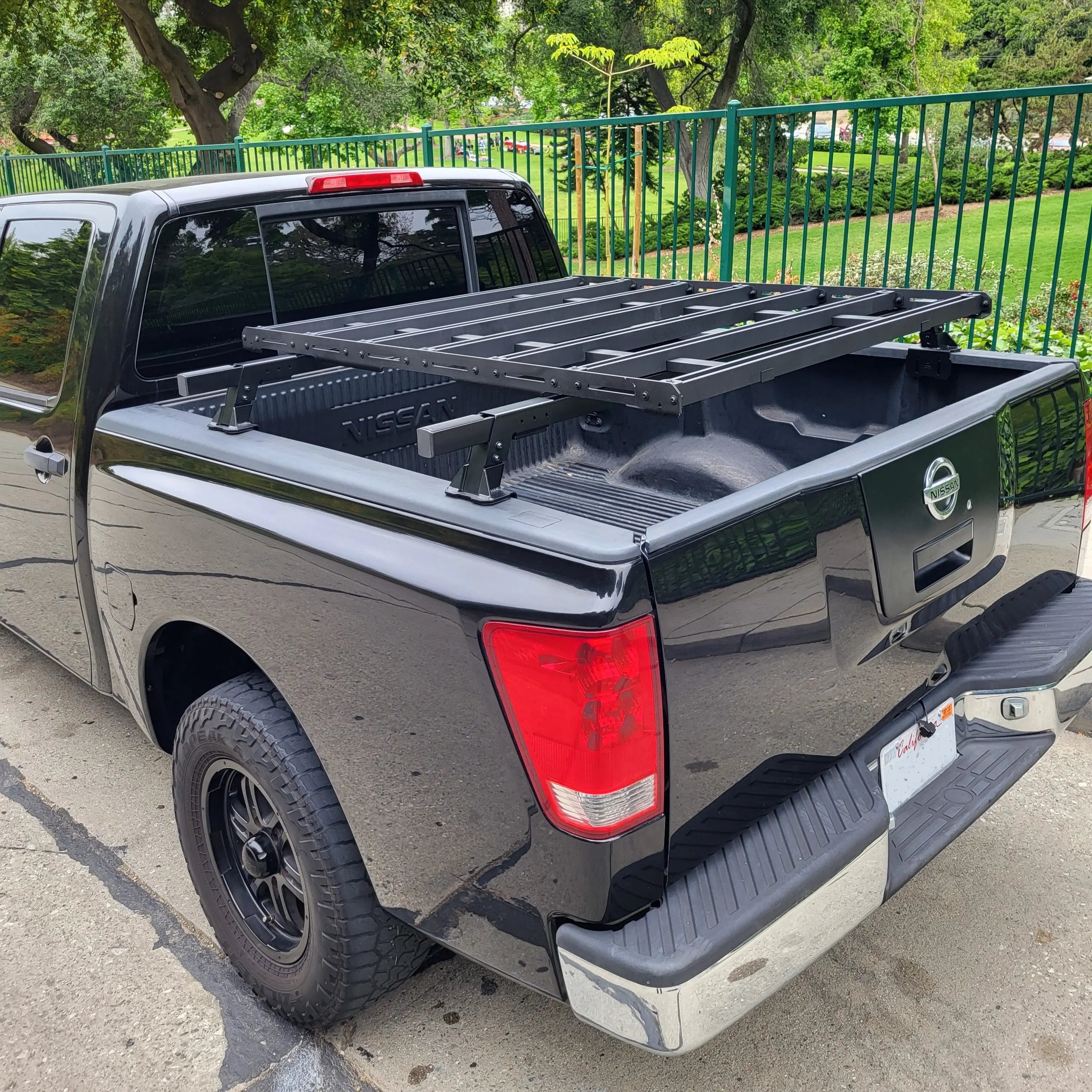 Black pickup truck with a platform rack in an outdoor setting