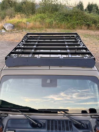 Roof rack system on a vehicle with a scenic background