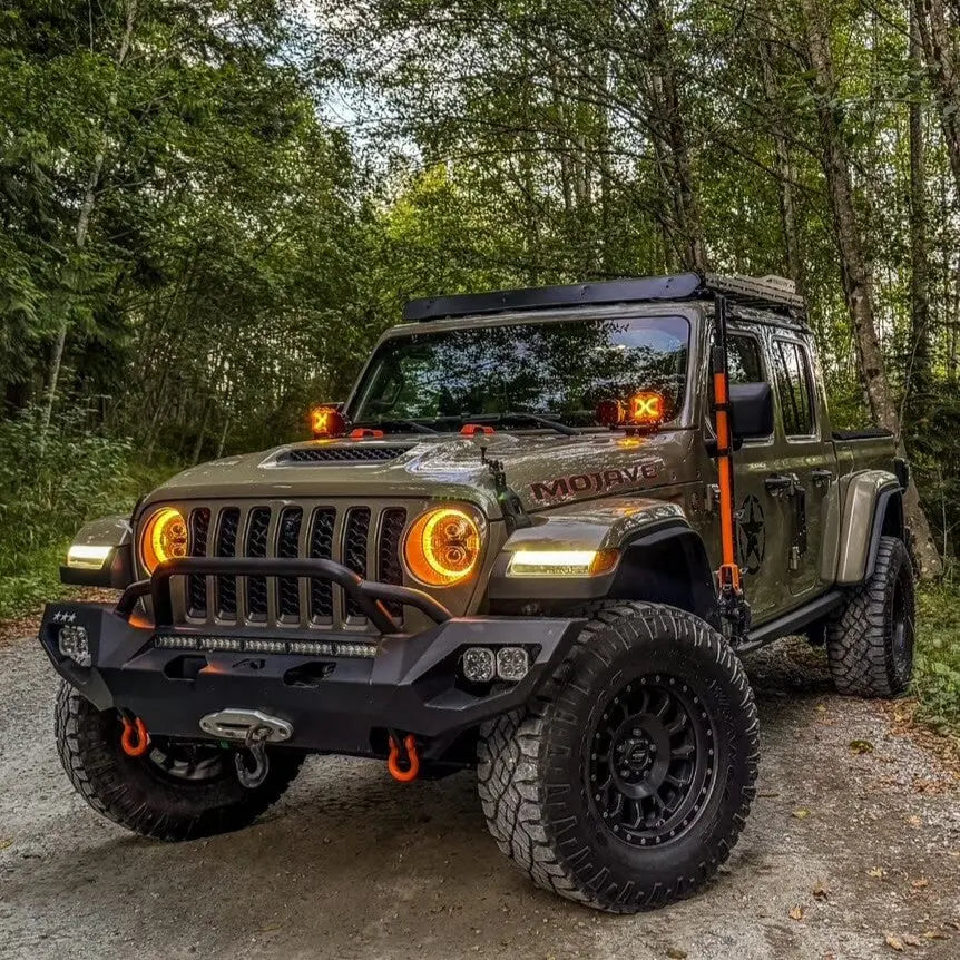 Jeep Wrangler in a forest setting with trees in the background and roof rack installed