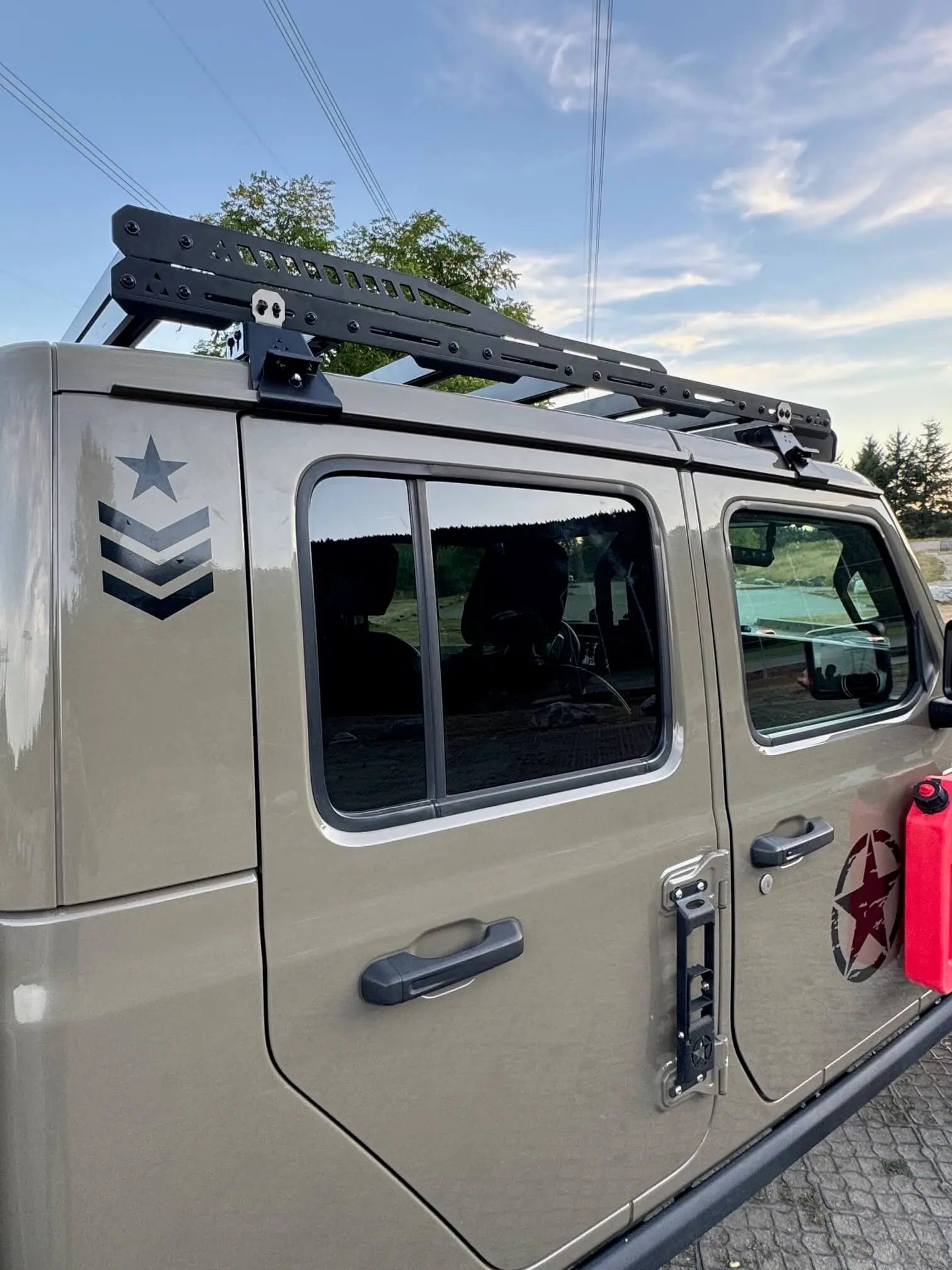 Jeep Gladiator with roof rack and star emblem on a clear day