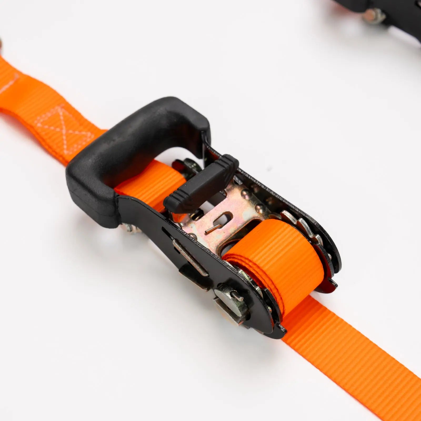 Close-up of an orange strap with a black buckle on a white background