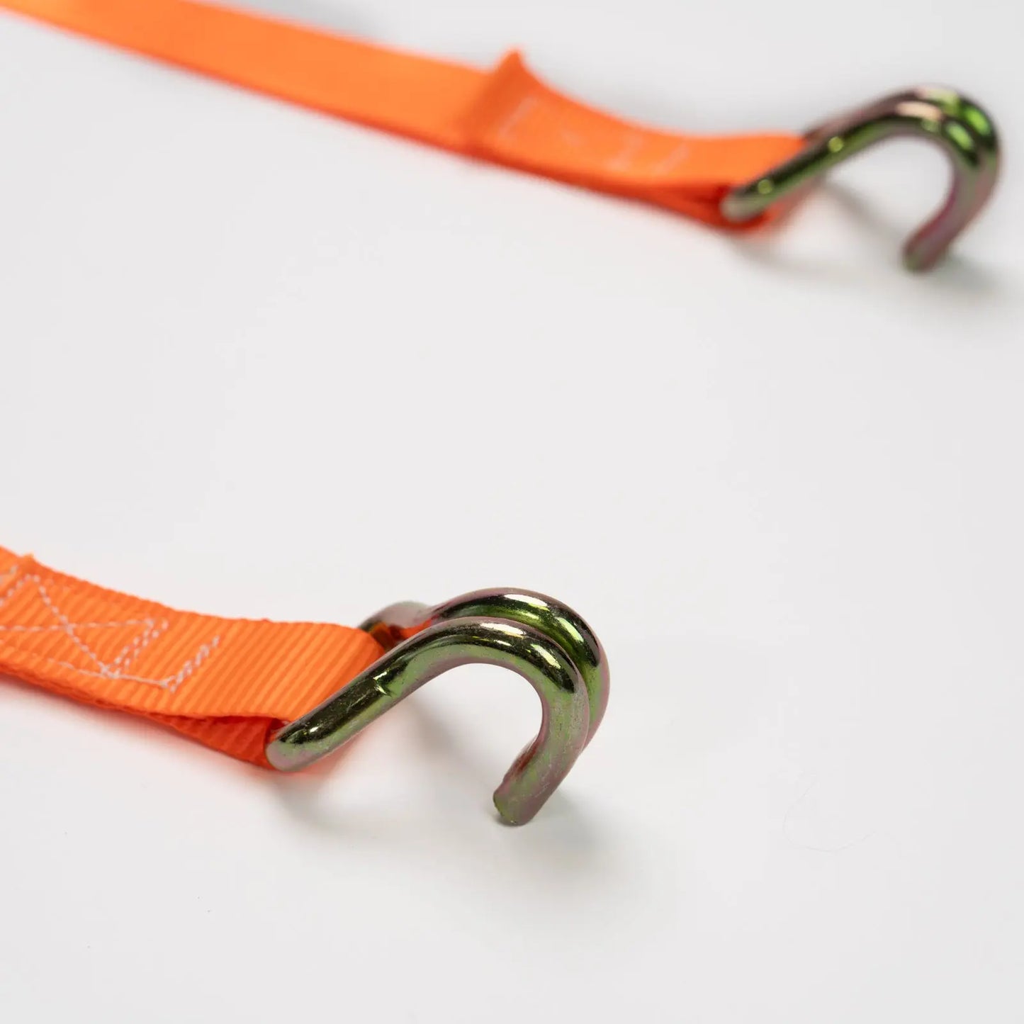 Orange strap with metal hooks on a white background