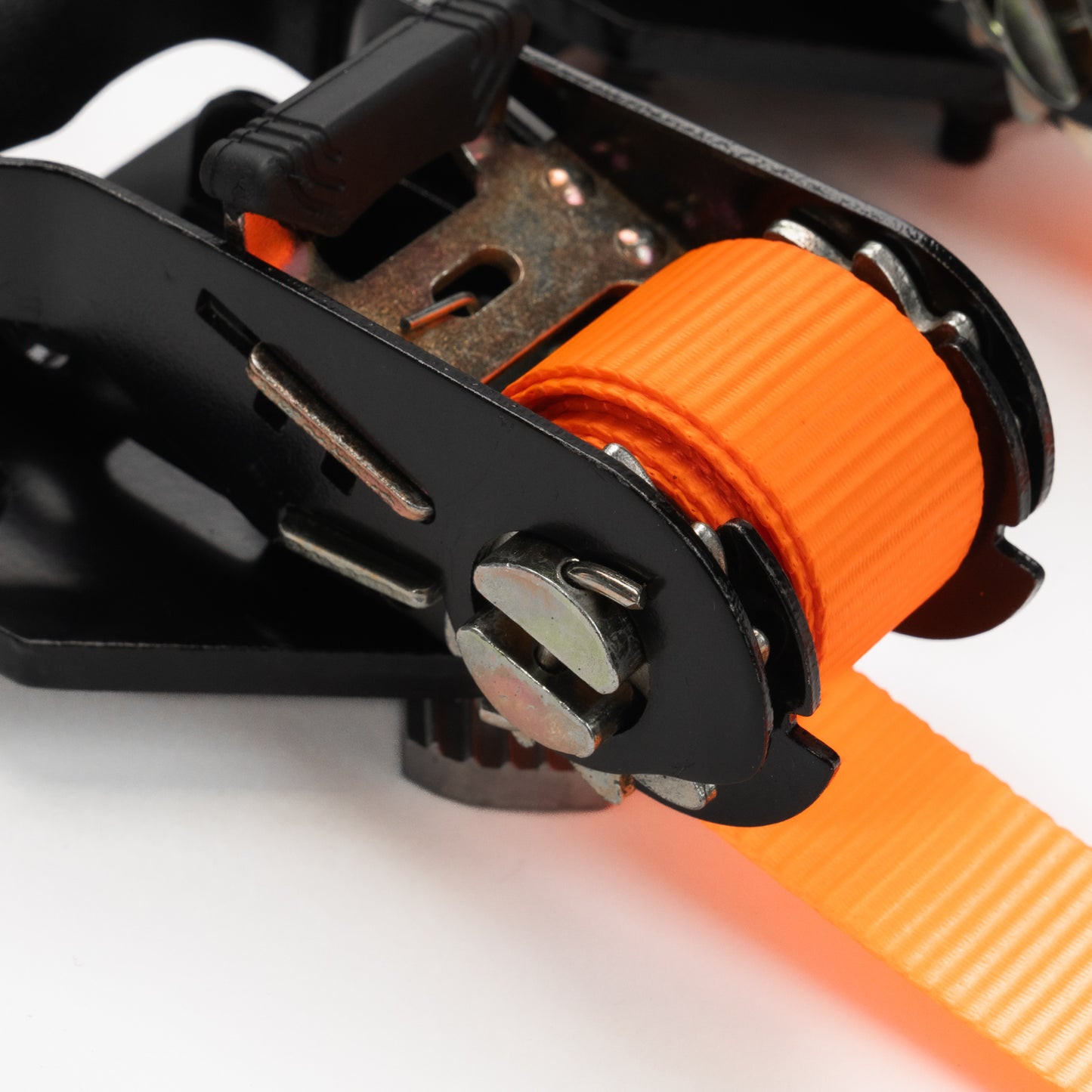 Close-up of an orange strap with a black buckle on a white background