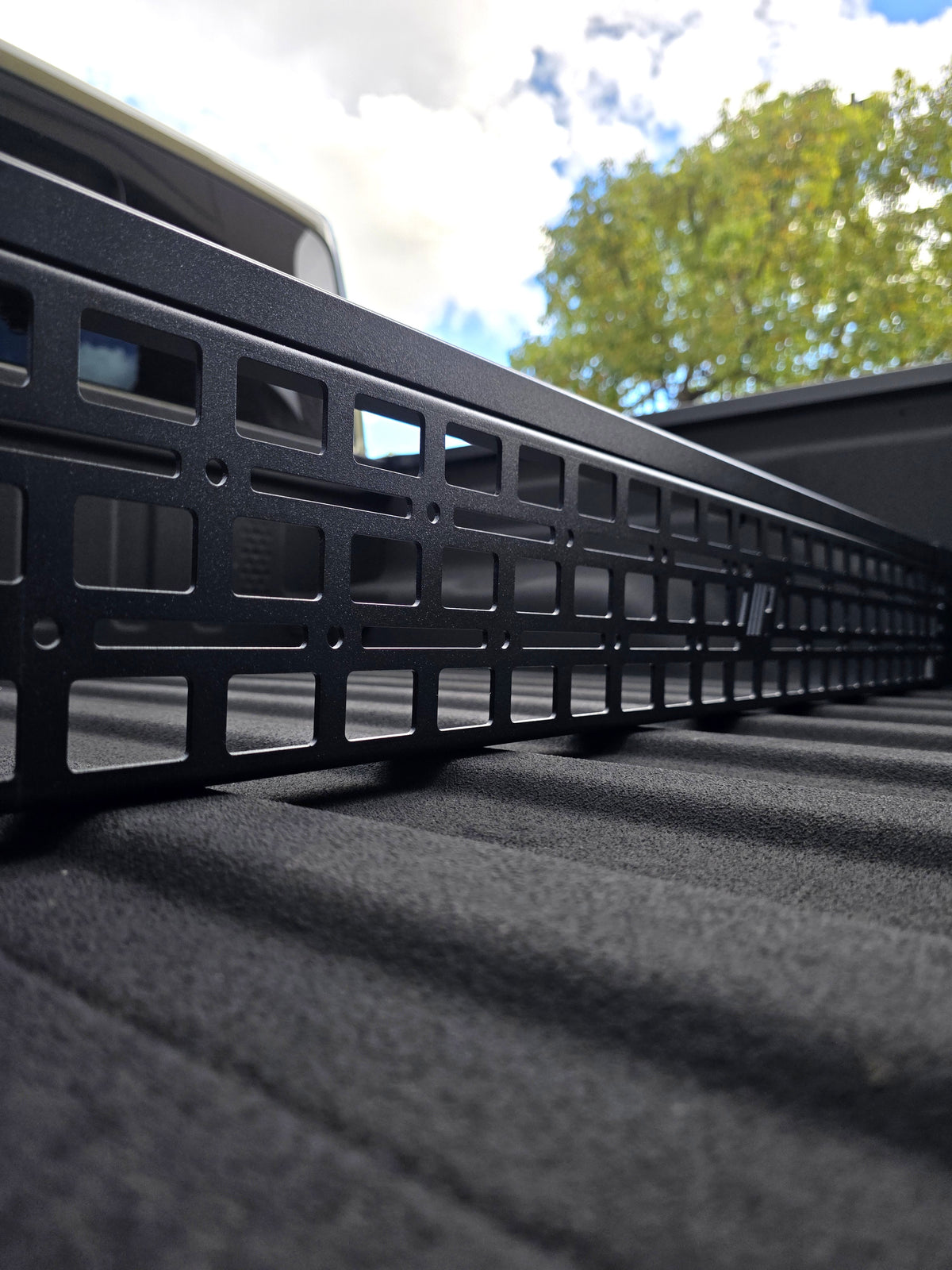 Close up view of b lack powder coated G2 Bed divider installed on Jeep Gladiator.