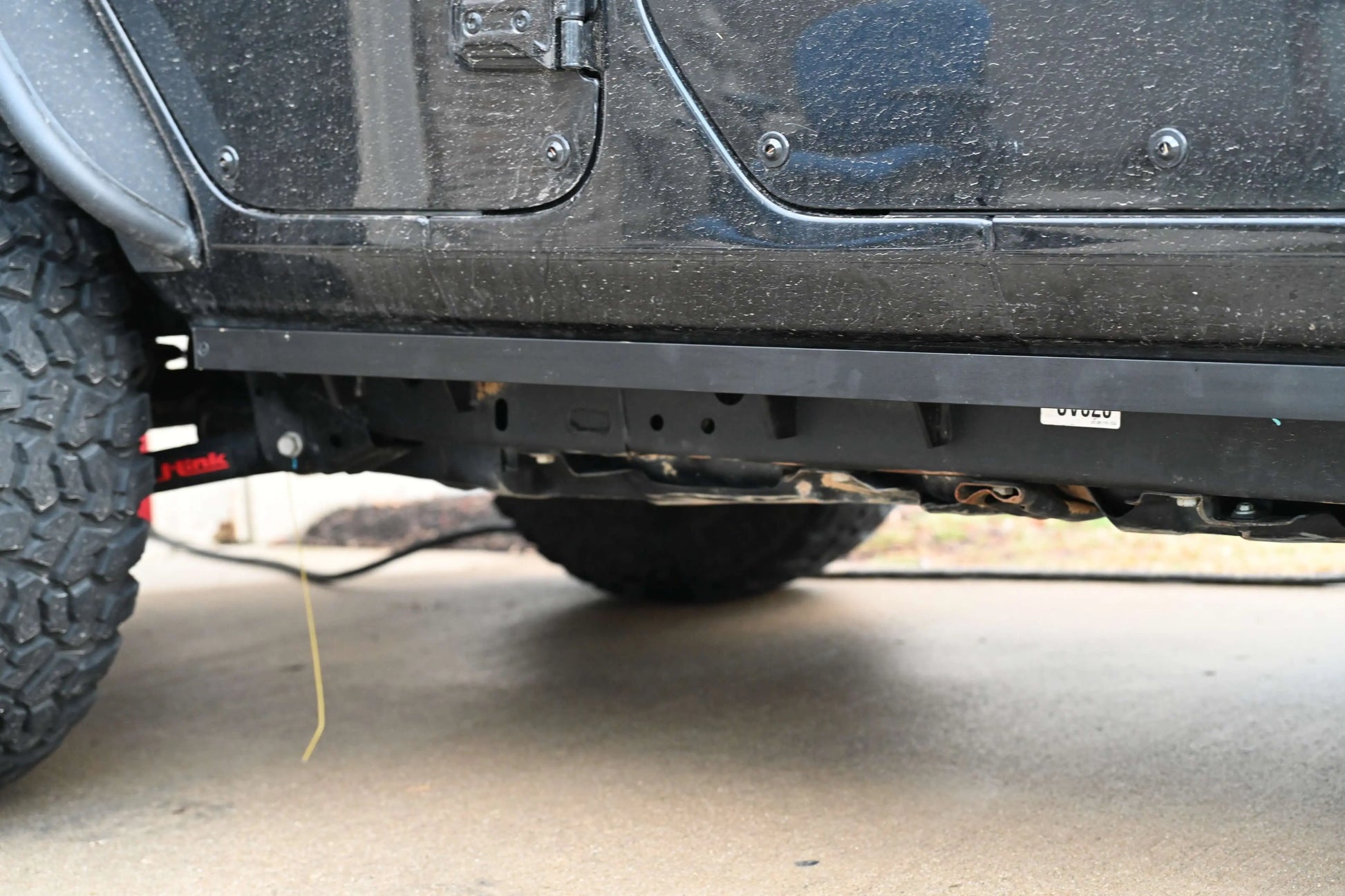 Black Jeep Wrangler JL with pinch weld covers installed, rear close up