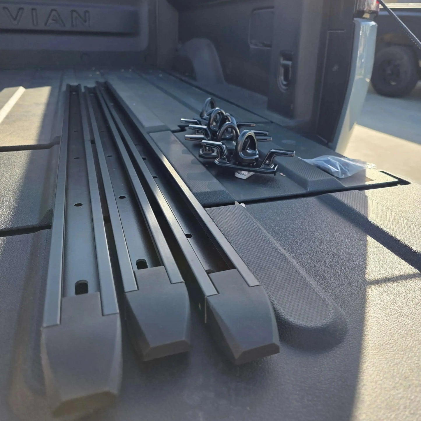 Rivian R1T cargo rail picture with tie downs