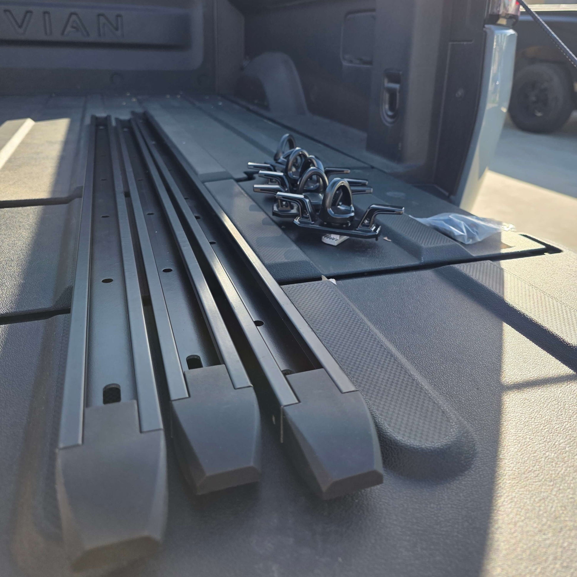 Rivian R1T cargo rail picture with tie downs